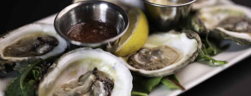 Freshly shucked Pink Moon oysters from Prince Edward Island, served on ice at The Tasting Room