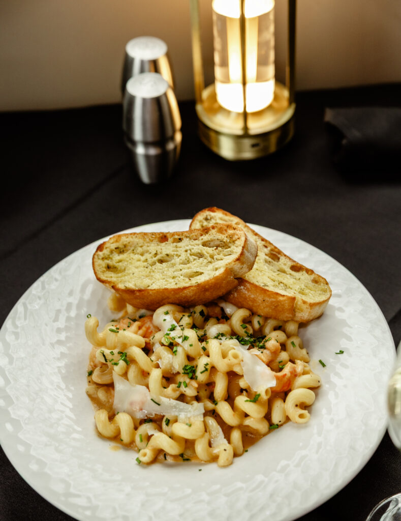 Langoustine lobster mac and cheese with cavatappi pasta and creamy cheese sauce.