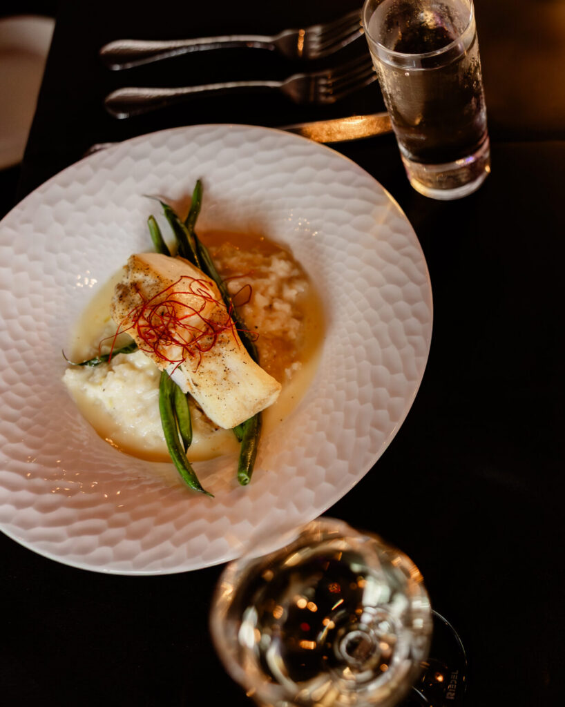 Pan-seared halibut served with Parmesan risotto, fresh vegetables, and Prosecco beurre blanc.